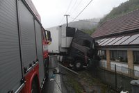Kamion zůstal zaklíněný v domě po bouračce s autem. Řidič osobáku zemřel