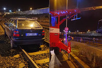 Řidič si spletl koleje a silnici: Auto musel vyprostit jeřáb
